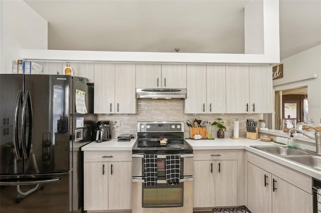 kitchen featuring light brown cabinets, black refrigerator, stainless steel electric range oven, sink, and backsplash