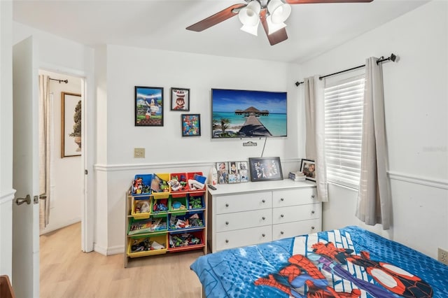 bedroom with light hardwood / wood-style floors and ceiling fan