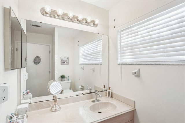 bathroom featuring toilet and vanity