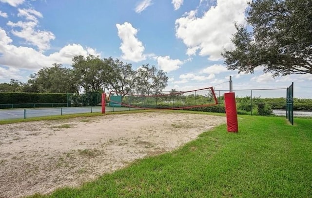 view of property's community with a yard and volleyball court