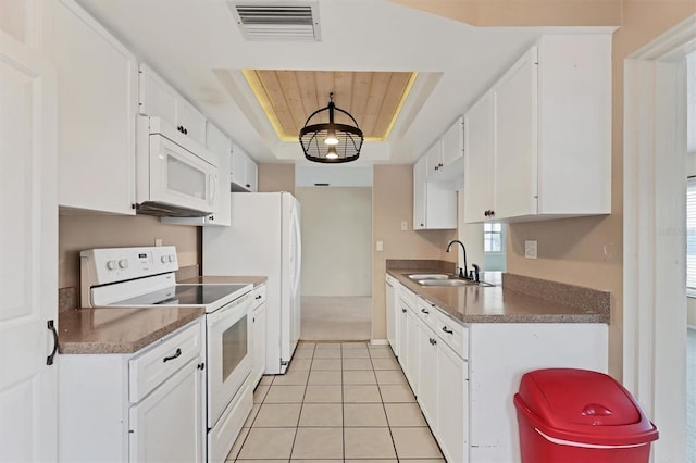 kitchen with sink, white cabinets, white appliances, a raised ceiling, and light tile patterned flooring