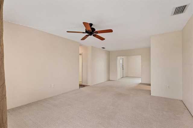 carpeted empty room featuring ceiling fan