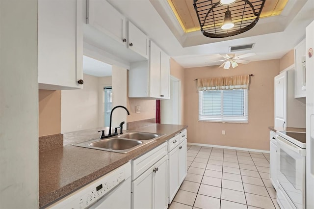 kitchen with sink, white cabinetry, white appliances, and a tray ceiling