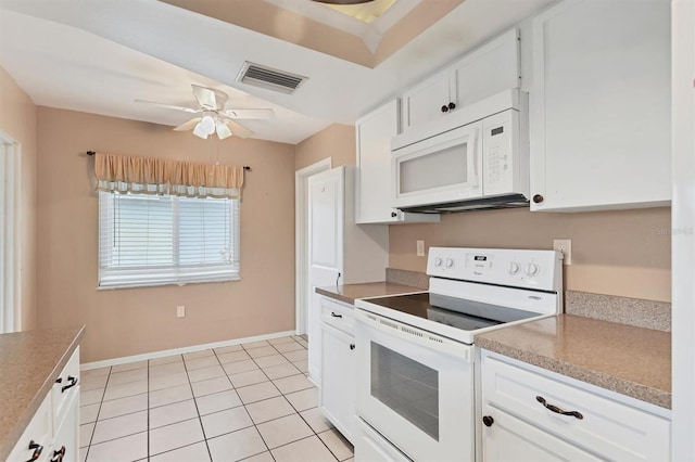 kitchen with white appliances, white cabinets, ceiling fan, and light tile patterned floors