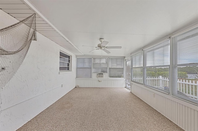 unfurnished sunroom with ceiling fan and cooling unit