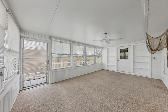 unfurnished sunroom featuring ceiling fan