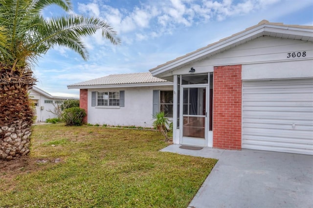 view of front of house with a front yard and a garage