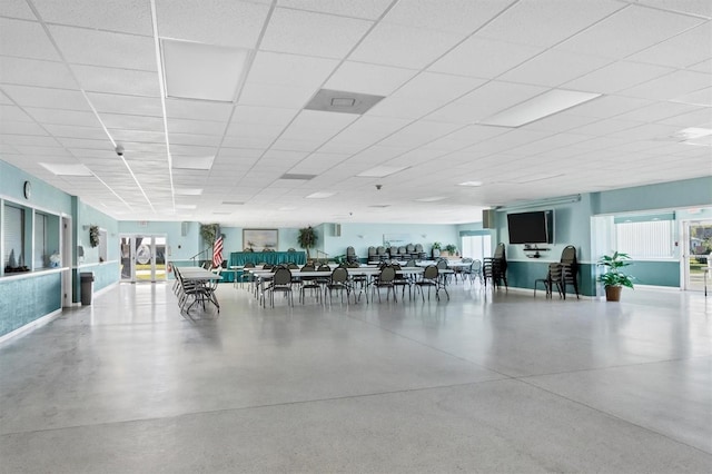 unfurnished dining area with a drop ceiling