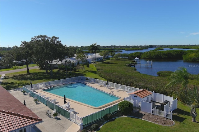 view of pool featuring a patio area and a water view