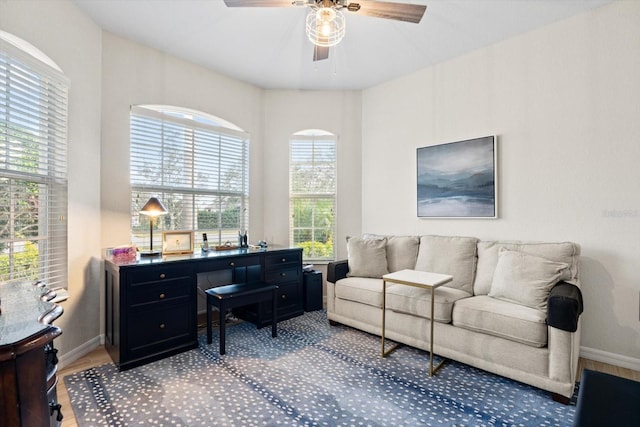 home office with hardwood / wood-style flooring and ceiling fan