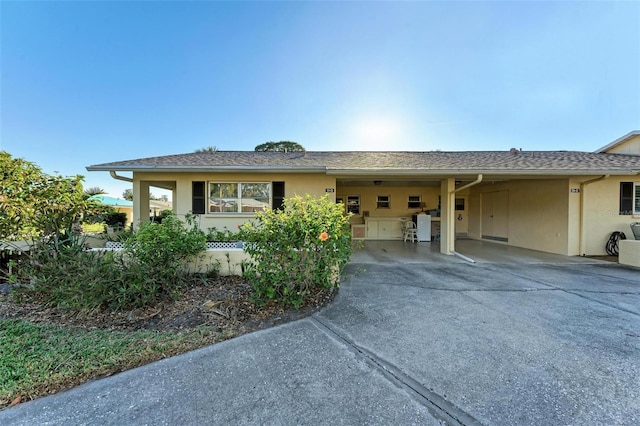 ranch-style home featuring a carport