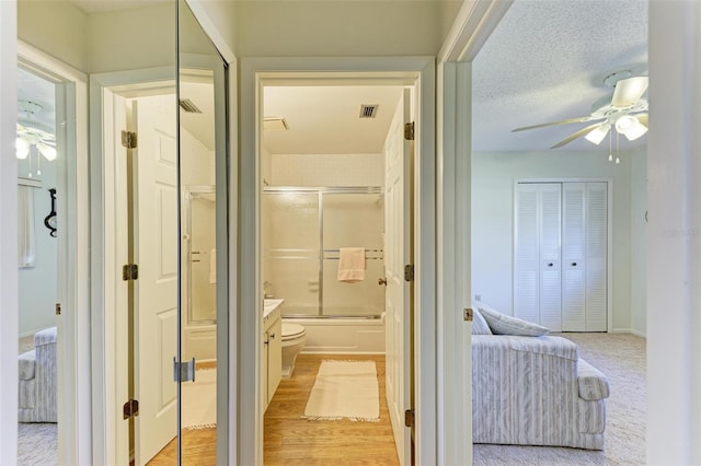 interior space featuring a textured ceiling and light hardwood / wood-style floors