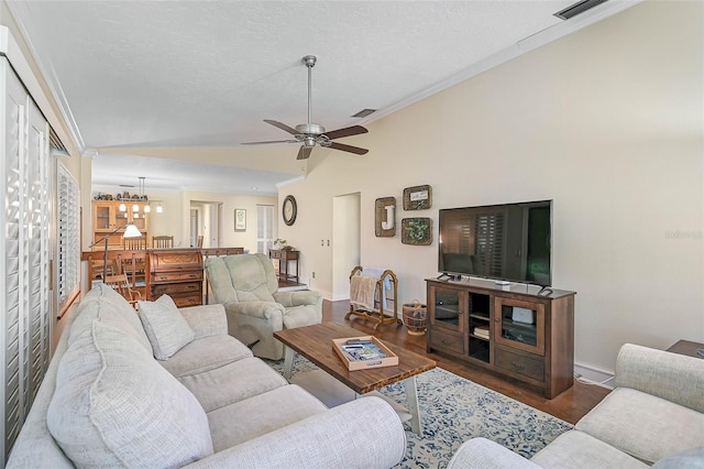 living room with ornamental molding, a textured ceiling, ceiling fan with notable chandelier, dark hardwood / wood-style floors, and lofted ceiling