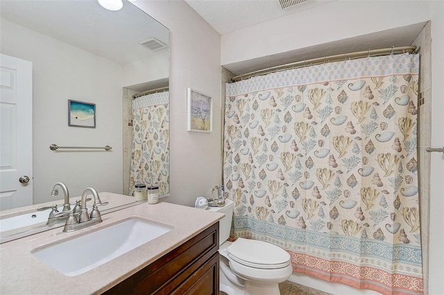 bathroom featuring curtained shower, vanity, and toilet