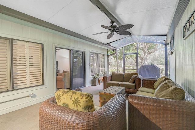 sunroom featuring ceiling fan and vaulted ceiling