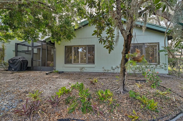 view of property exterior featuring glass enclosure