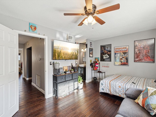 bedroom with a ceiling fan, baseboards, visible vents, and wood-type flooring