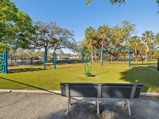 community playground featuring a lawn and fence