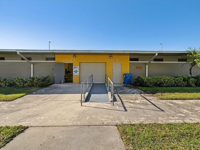 view of property with concrete driveway and an attached garage