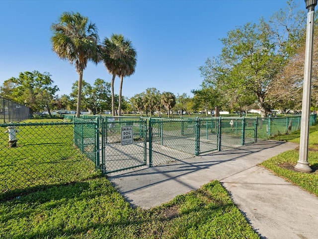 surrounding community featuring fence, a yard, and a gate