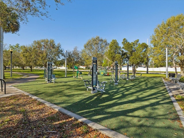 view of property's community with a lawn and playground community