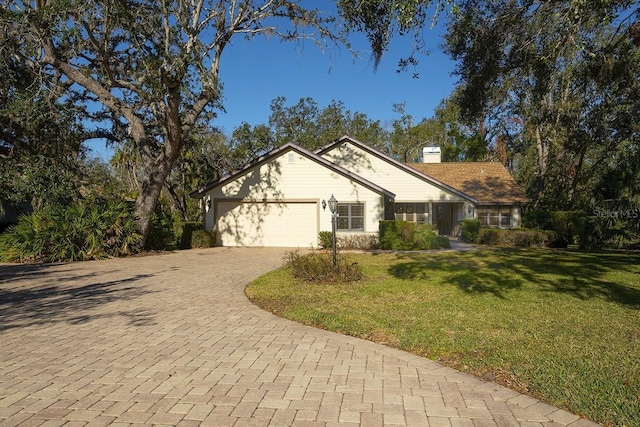 view of front of home featuring a front yard and a garage