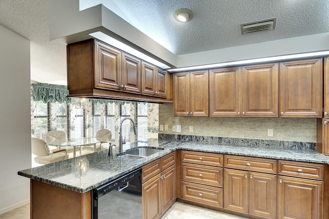 kitchen with kitchen peninsula, a textured ceiling, sink, dark stone countertops, and black dishwasher