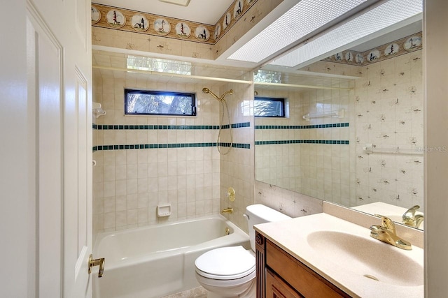 full bathroom featuring vanity, toilet, and tiled shower / bath