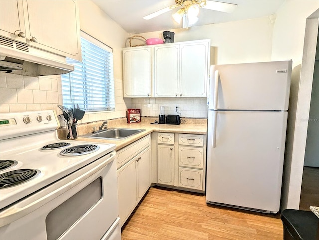 kitchen with decorative backsplash, light wood-type flooring, white appliances, and sink