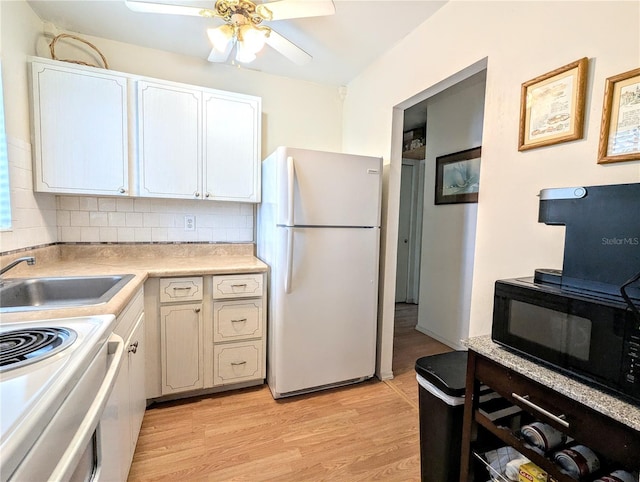 kitchen with white appliances, light wood-style floors, light countertops, decorative backsplash, and ceiling fan
