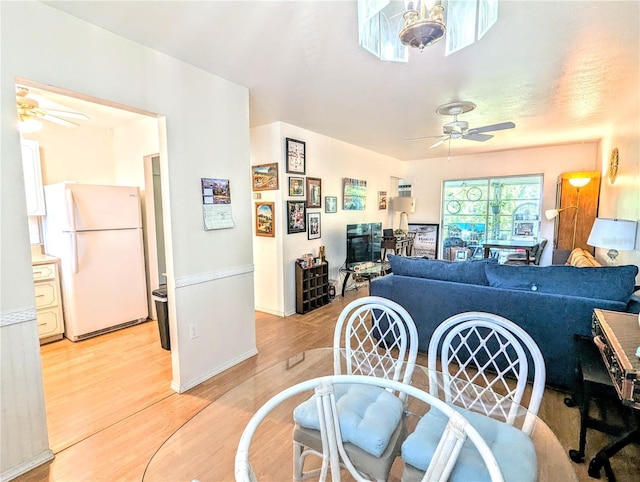 dining room with light wood-style flooring and a ceiling fan
