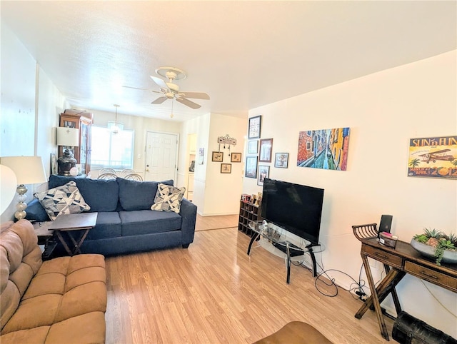 living room featuring a ceiling fan and light wood finished floors