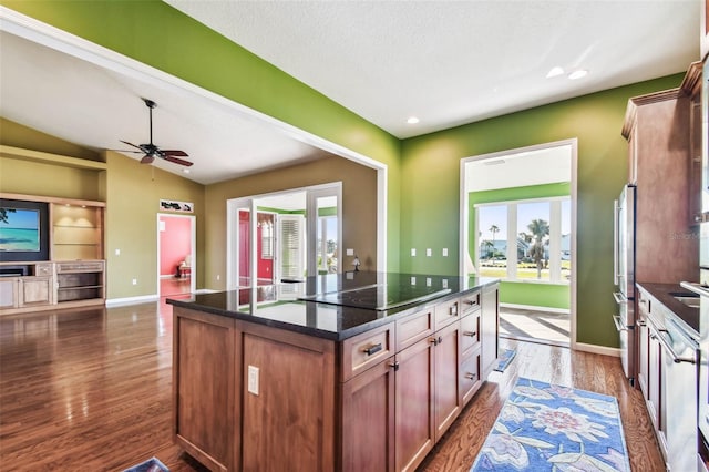 kitchen with a center island, lofted ceiling, french doors, black electric stovetop, and dark hardwood / wood-style floors