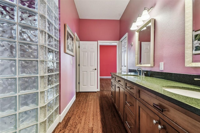 bathroom with hardwood / wood-style floors and vanity