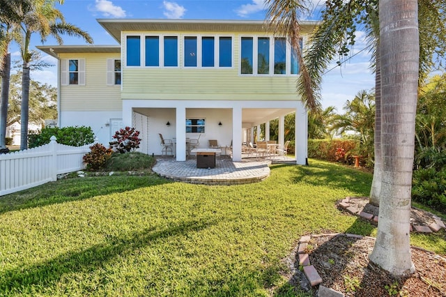 back of house with a yard and a patio