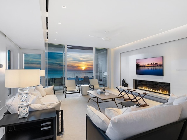 living room featuring a wall of windows and light colored carpet