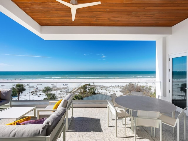 balcony featuring a view of the beach and a water view