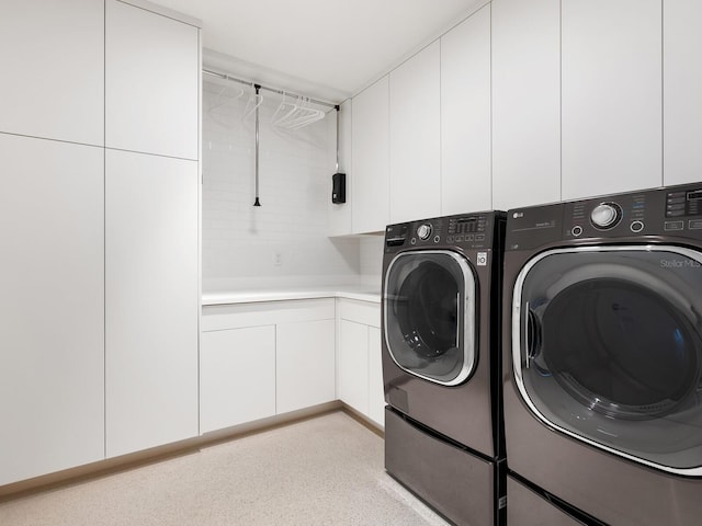 laundry area featuring cabinet space and separate washer and dryer