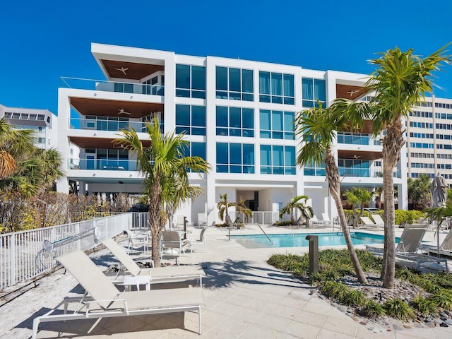 community pool featuring a patio and fence