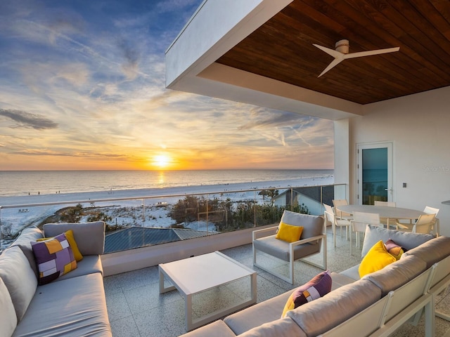 view of patio / terrace with a beach view, a balcony, ceiling fan, an outdoor hangout area, and a water view