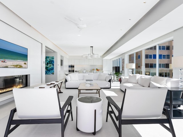 living area featuring a glass covered fireplace