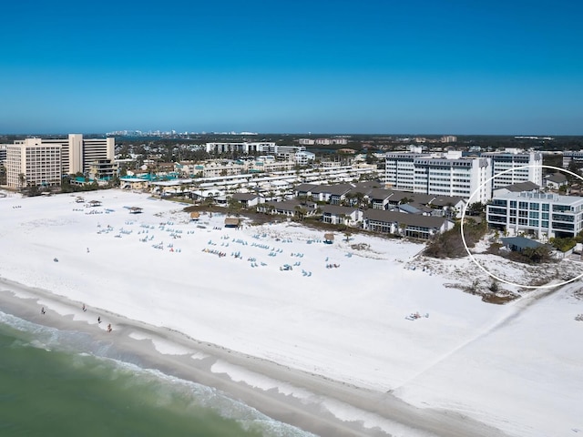 birds eye view of property featuring a beach view and a city view