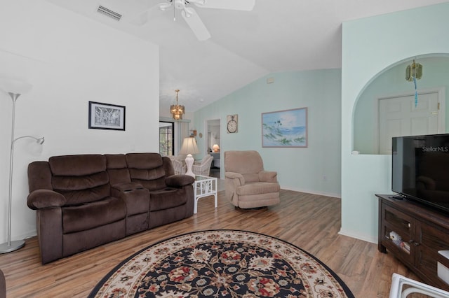 living room featuring ceiling fan, light wood-type flooring, and vaulted ceiling