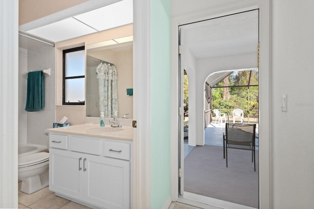 bathroom with tile patterned flooring, vanity, and toilet