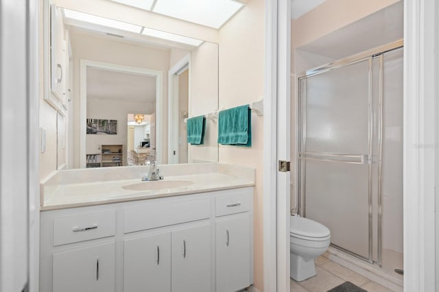 bathroom with tile patterned flooring, vanity, toilet, and a shower with shower door