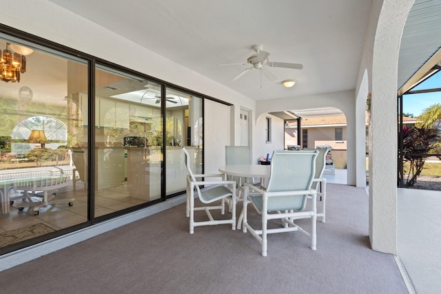 sunroom featuring ceiling fan