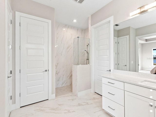 bathroom featuring vanity and a tile shower