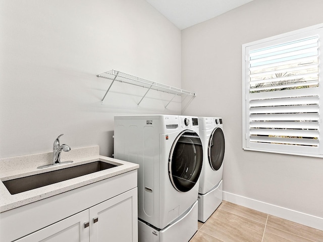 clothes washing area featuring washer and clothes dryer and sink