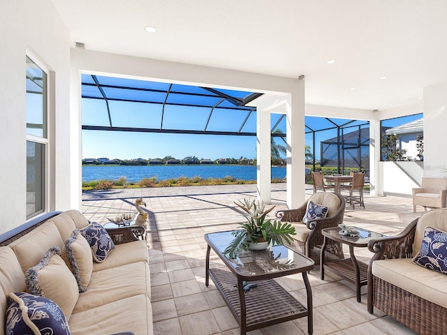 view of patio / terrace with an outdoor hangout area, a water view, and glass enclosure