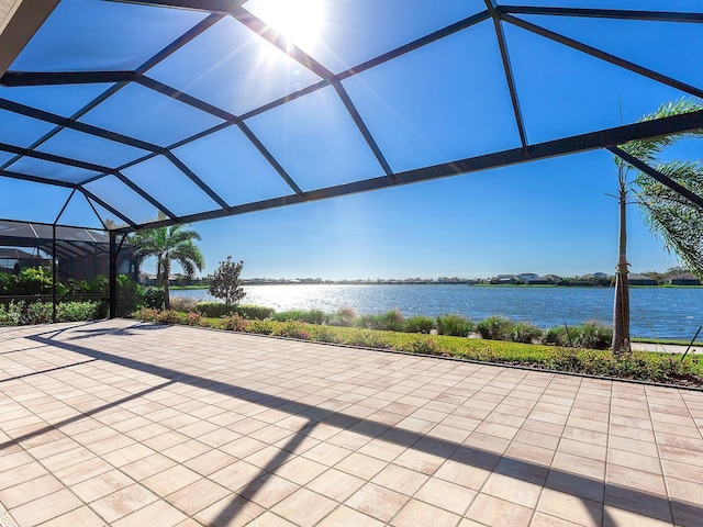 view of patio / terrace featuring a water view and a lanai